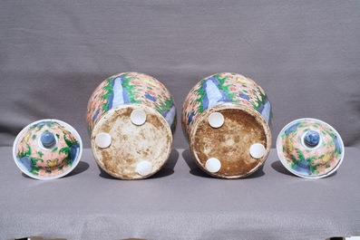 A pair of Chinese wucai 'galloping horses' vases and covers, Transitional period